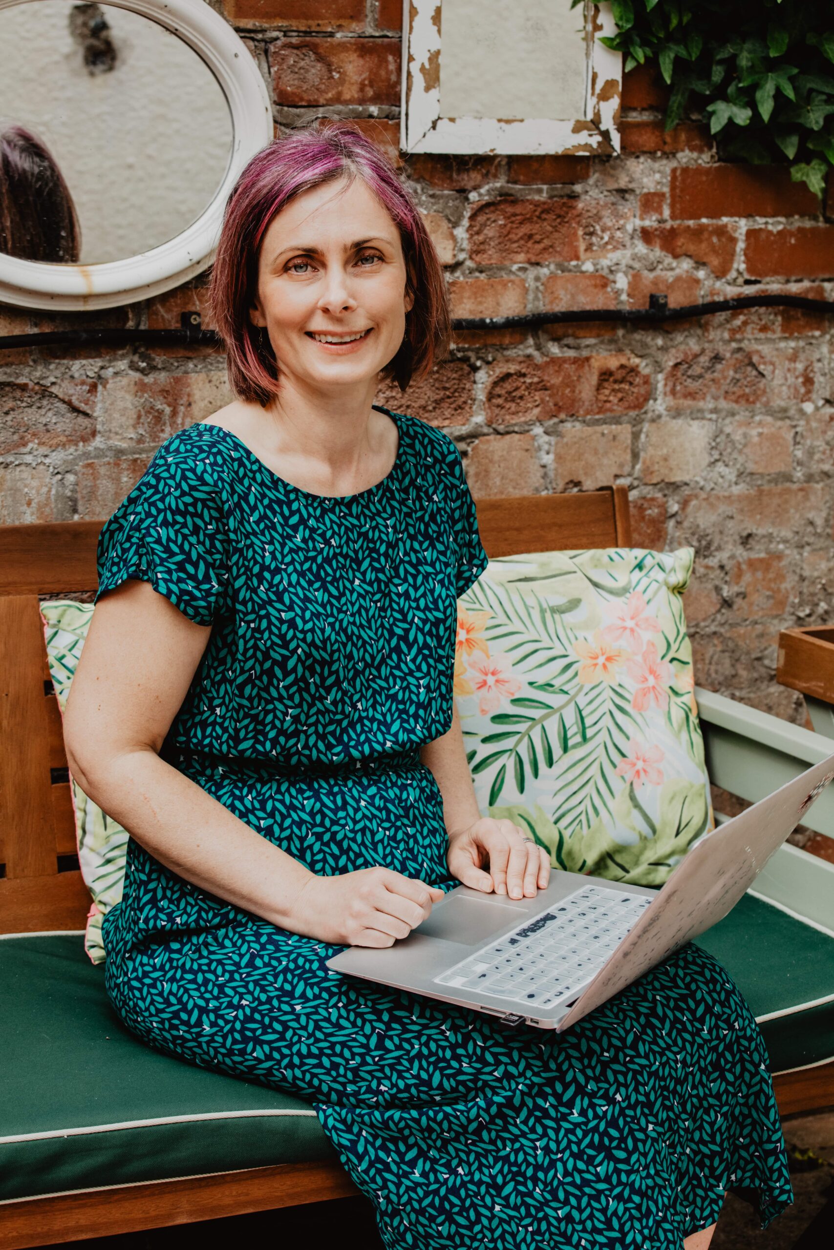 laura walker pictured sat outside with laptop looking at camera